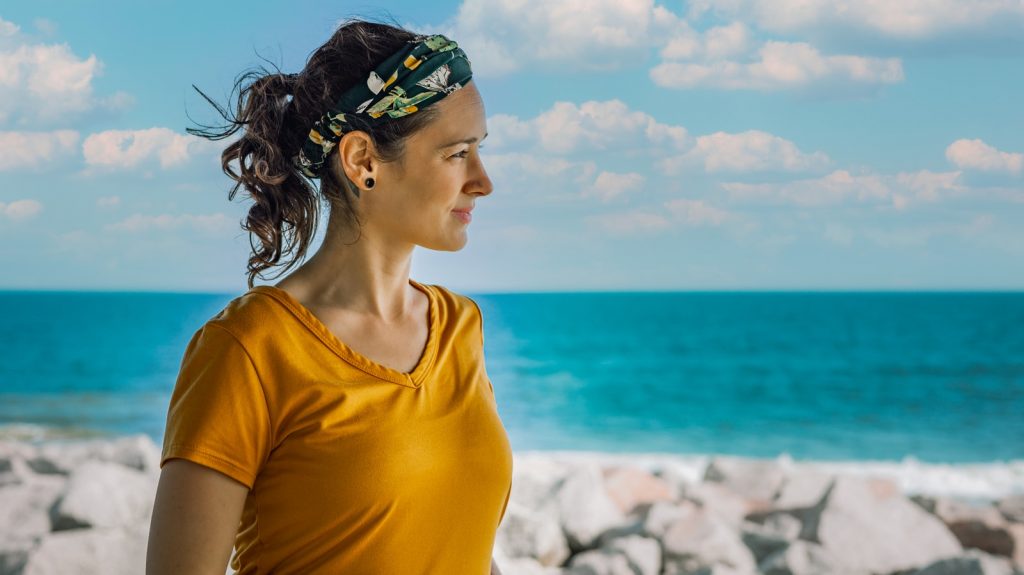 woman in yellow crew neck shirt wearing green and blue floral headband